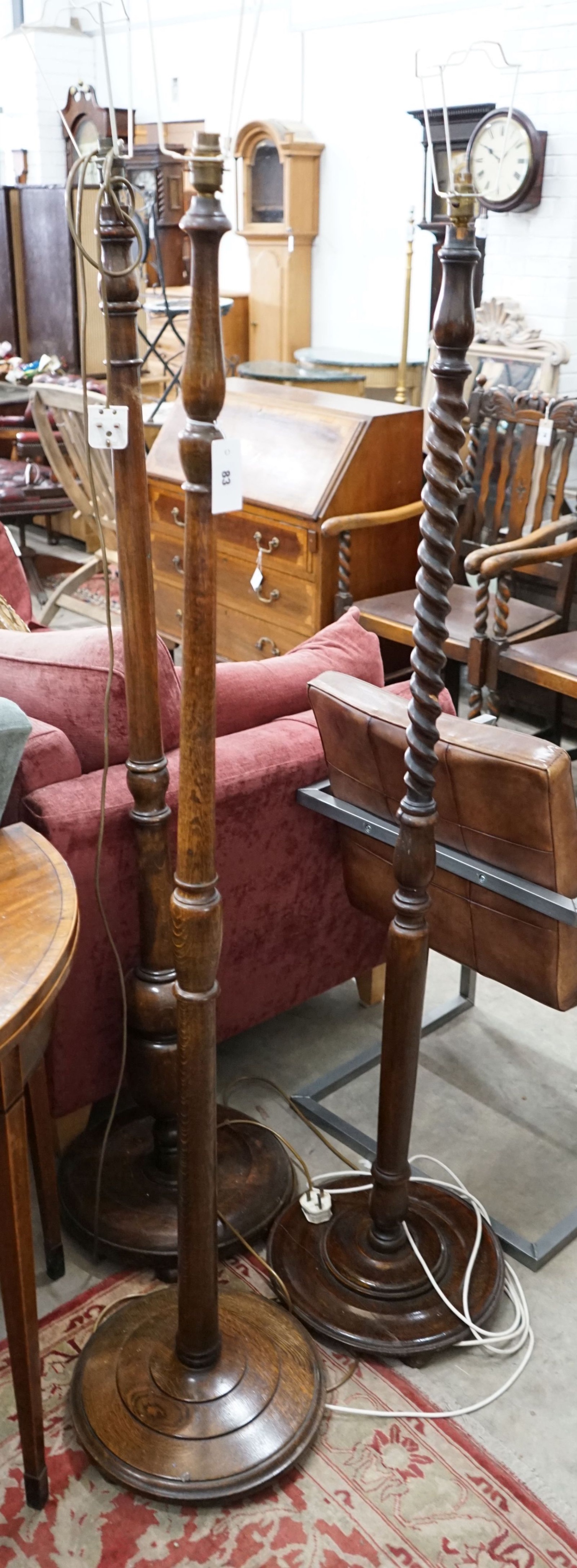 Three various oak standard lamps (excluding shades)